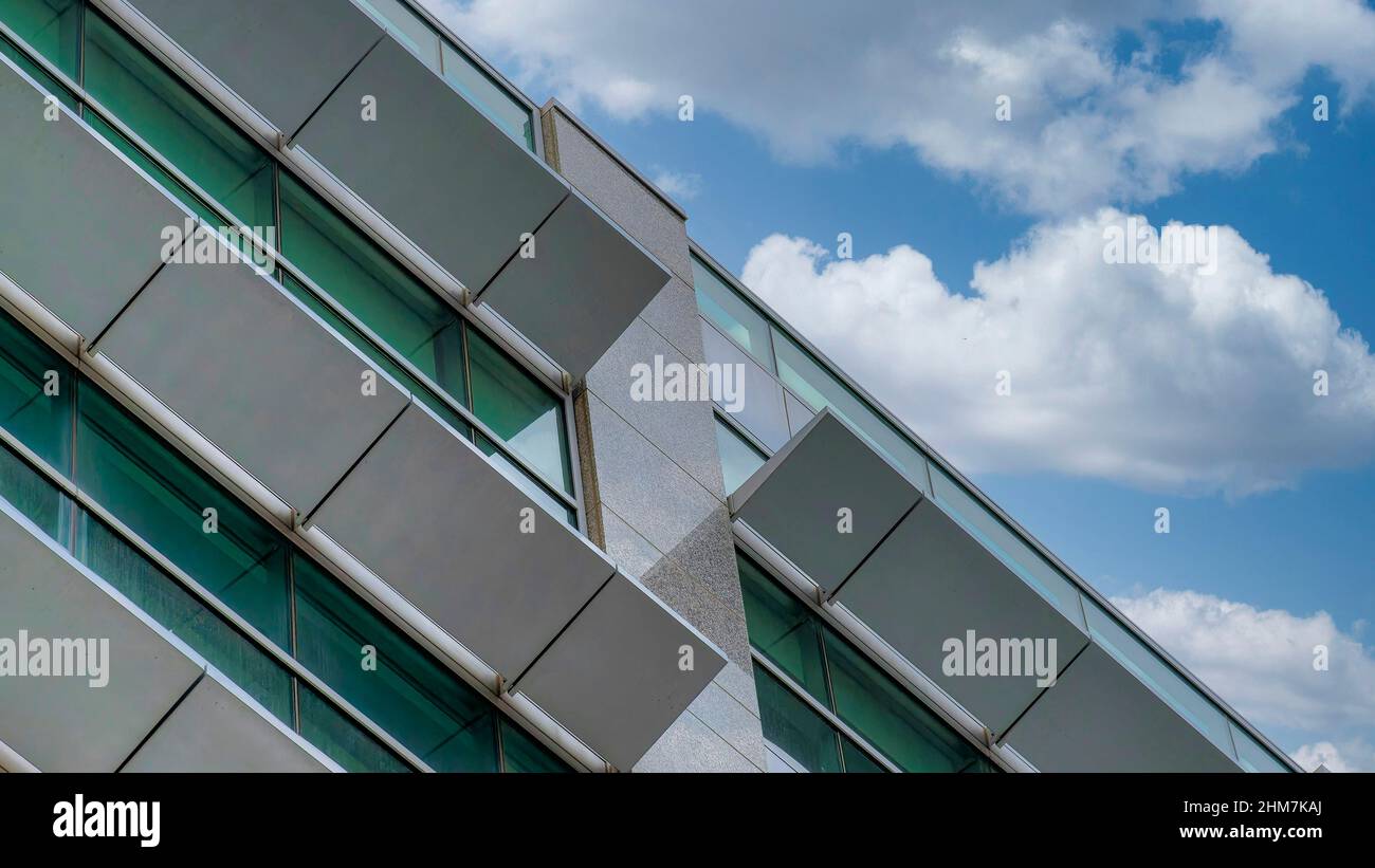 Panorama White puffy clouds Low angle view of a building with opened  sunshade panels at Salt Stock Photo - Alamy