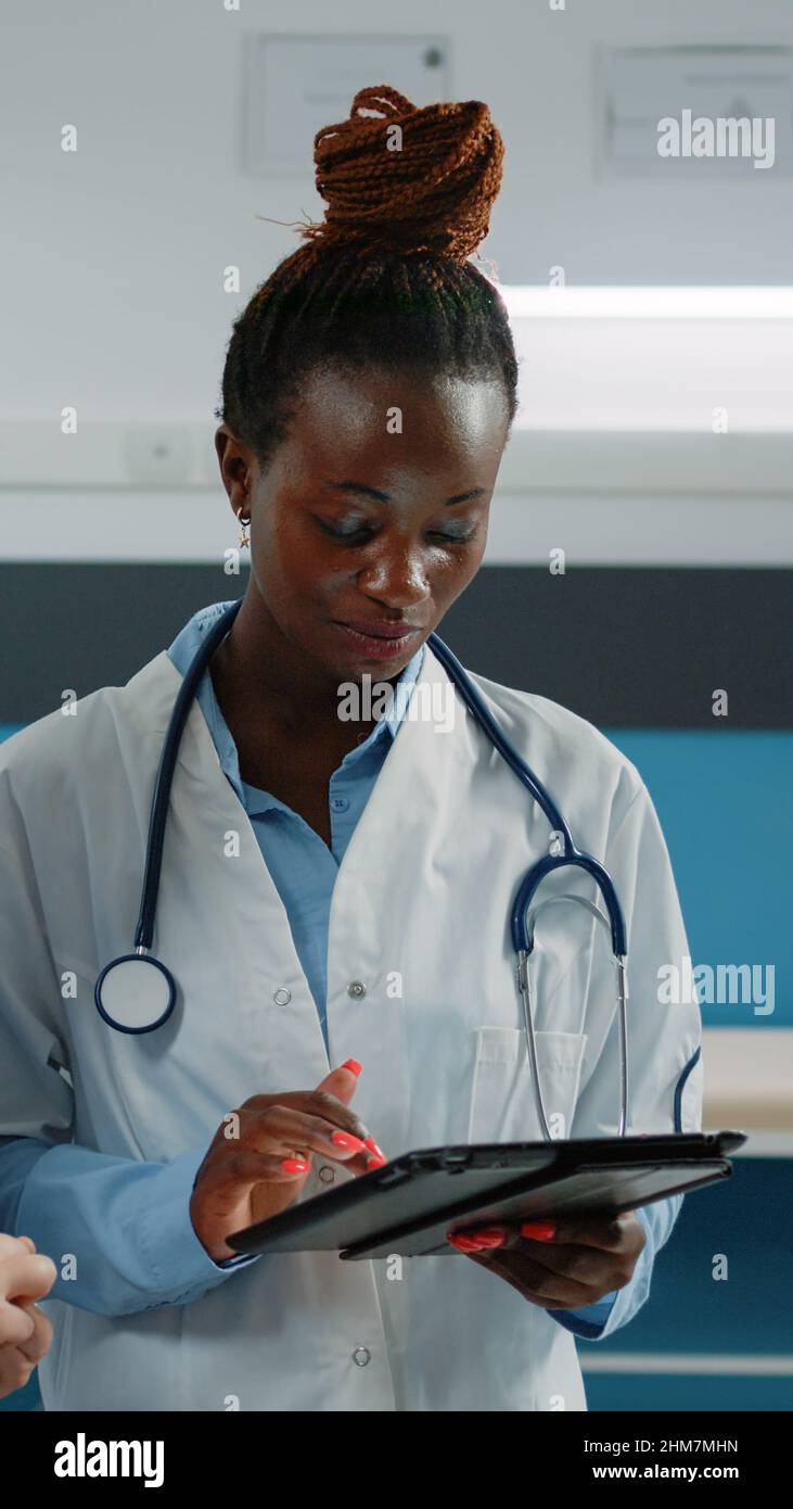 Group of medical workers using tablet for consultation and patient