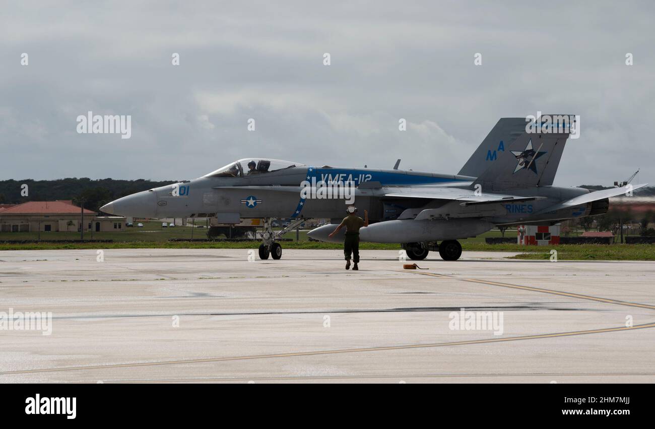 A U.S. Marine Fighter Attack Squadron 112 F-18C Hornet marshals on Andersen Air Force Base, Guam, after a training sortie on Jan. 28, 2022. The Marine Aviation Logistics Squadron 12 and MFAS 112 performed the ordnance load to maintain proficiency standards and for unit cohesion for upcoming exercises. (Senior Airman Michael S. Murphy) Stock Photo