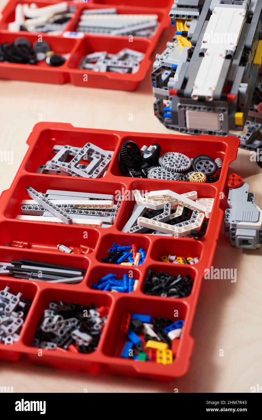 Vertical background image of plastic construction set parts on table in robotics and engineer class in modern school, copy space Stock Photo