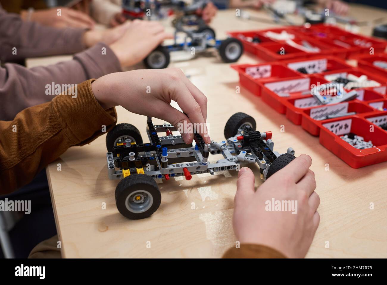 Close up of unrecognizable boy building electric car in robotics and engineering class at school, copy space Stock Photo