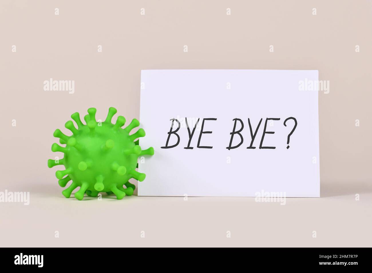 Concept for end of Corona virus pandemic with virus model and note with text 'Bye Bye?' Stock Photo