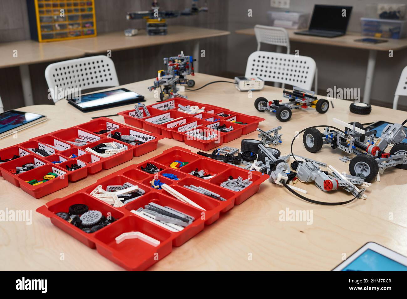 Background image of robot construction set parts in containers on table in robotics and engineer class at modern school, copy space Stock Photo