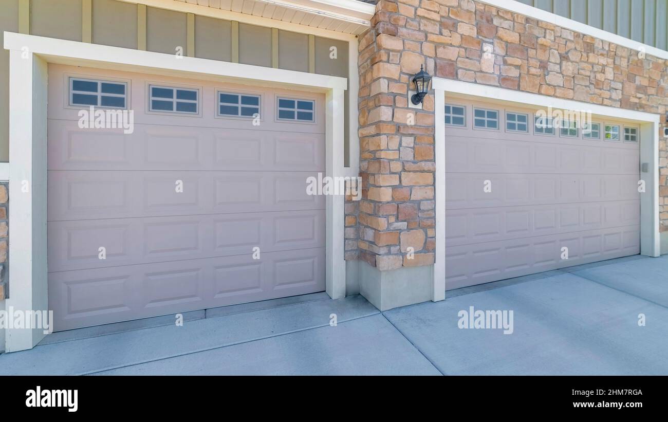 Panorama Three car garage exterior with stone veneer and green board ...