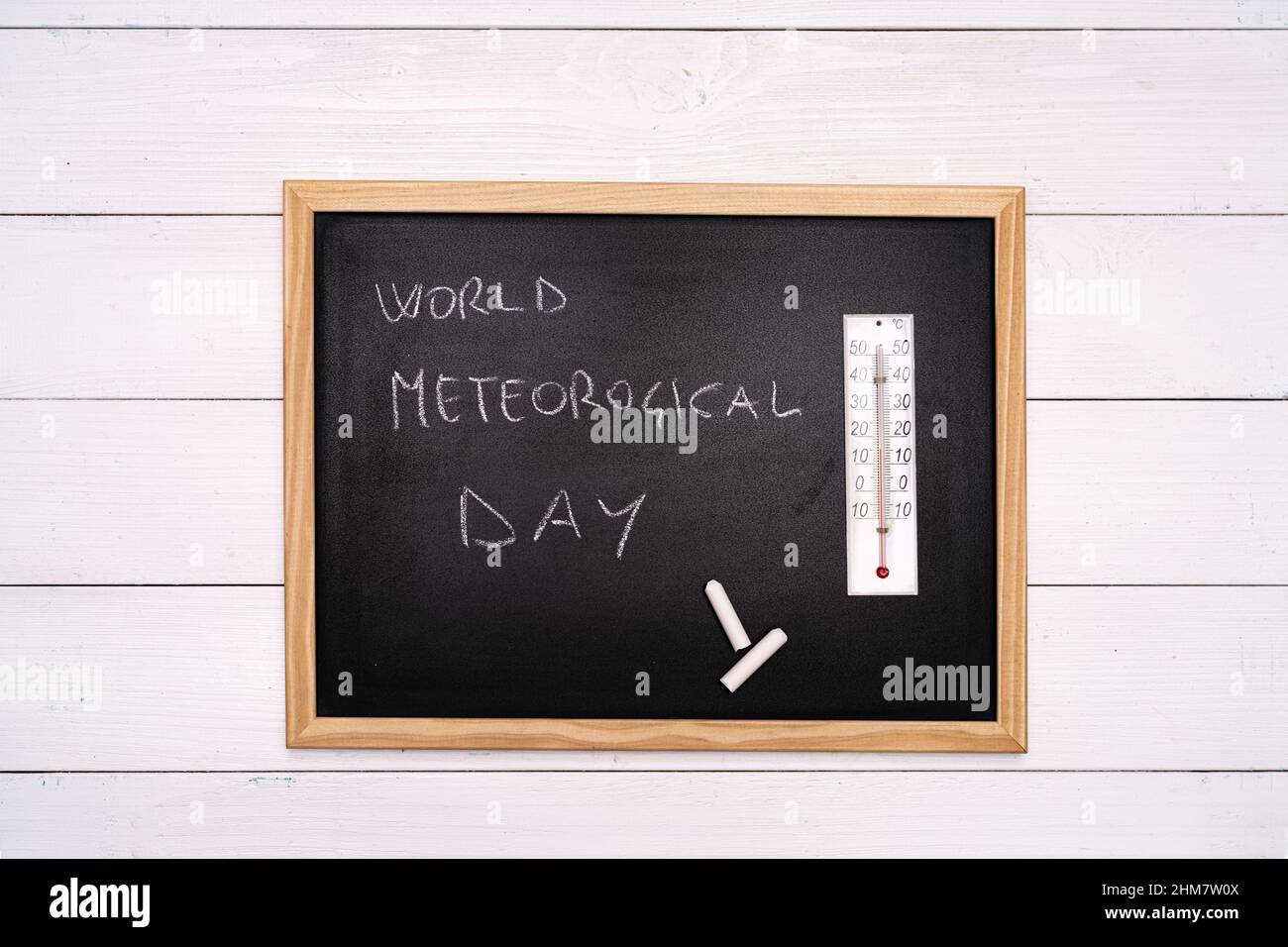 World Meteorological Day write on a blackboard with a chalk and a thermometer Stock Photo