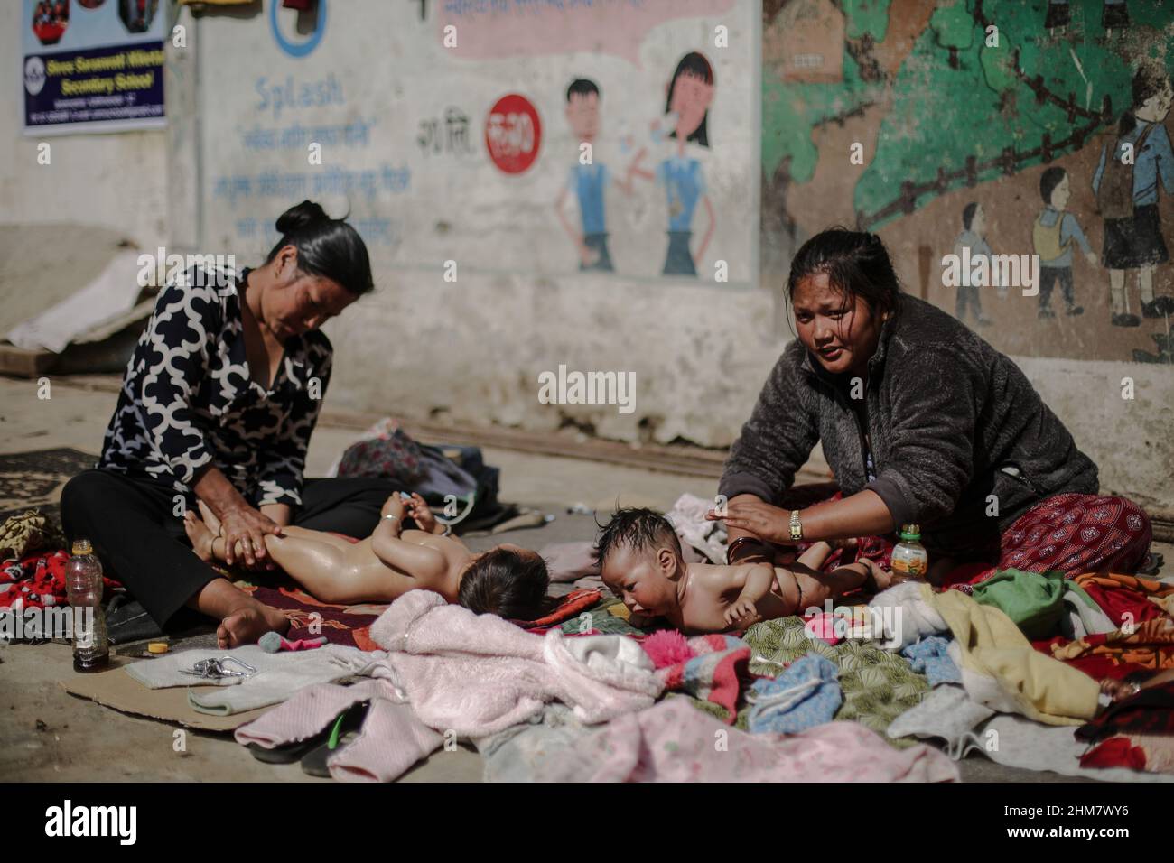 Bhaktapur, Bagmati, Nepal. 8th Feb, 2022. Mothers gives oil massage to