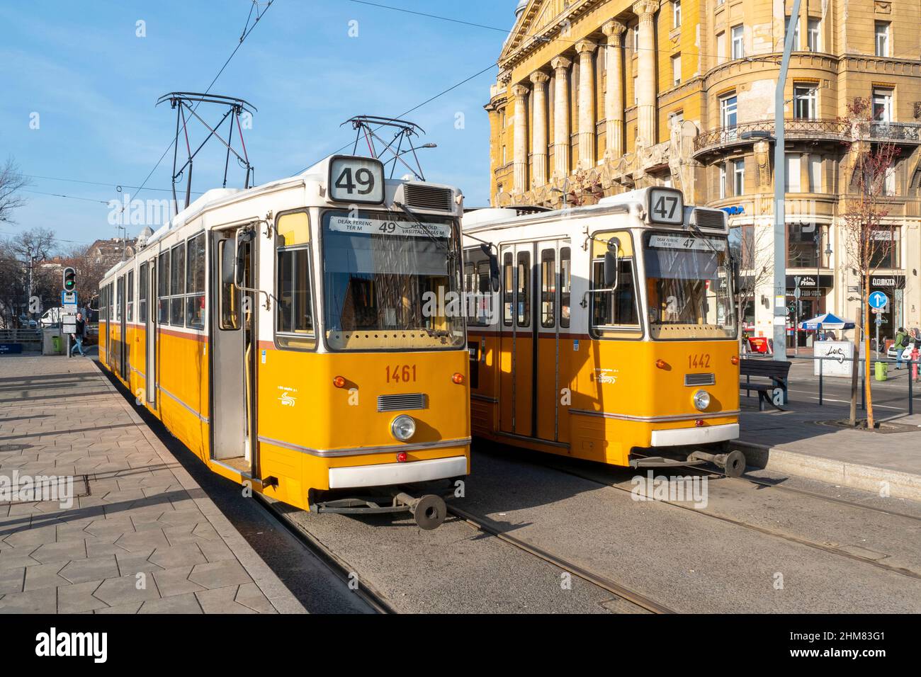 BUDAPEST - JAN 20: Two traditional yellow tramways in a street of Budapest, January 20. 2022 in Hungary Stock Photo