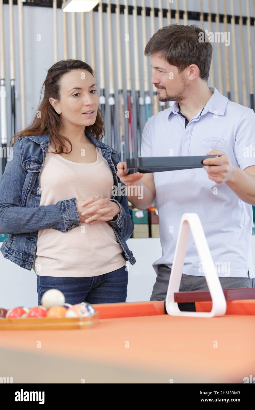couple choosing a triangle rack Stock Photo Alamy