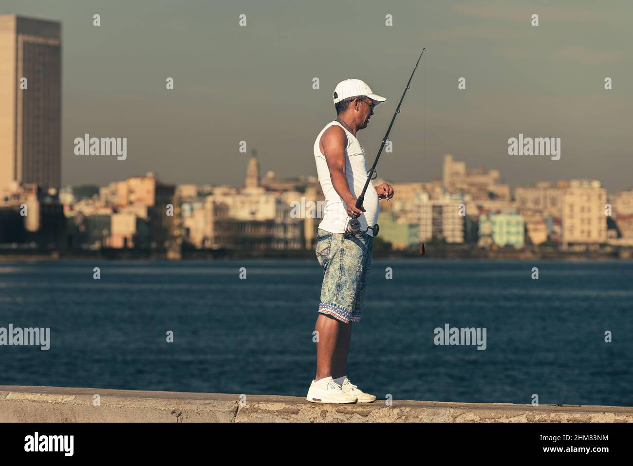 Cuban fisherman with Havana city in background Stock Photo
