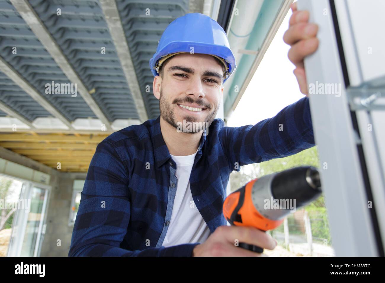 man drilling a window frame Stock Photo Alamy