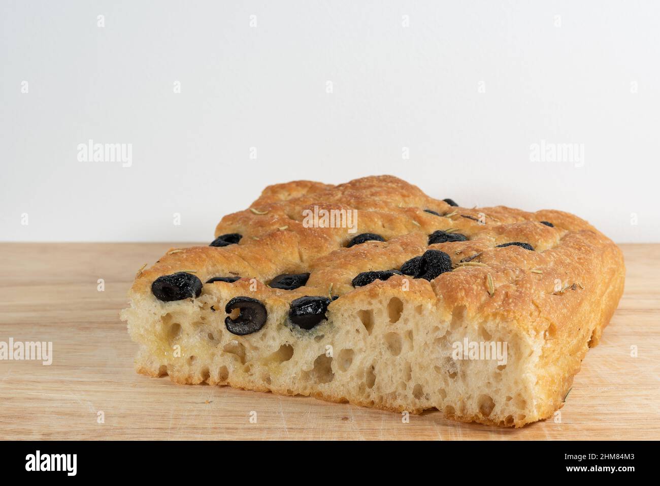 Original Italian focaccia genovese with black olives and rosemary. Traditional and delicious Italian salty food. Stock Photo