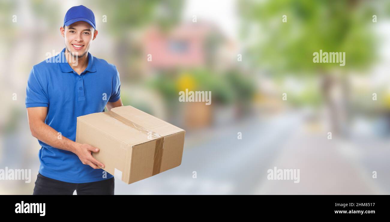 Young latin man delivering parcel delivery service package order banner job education town copyspace copy space outdoors Stock Photo