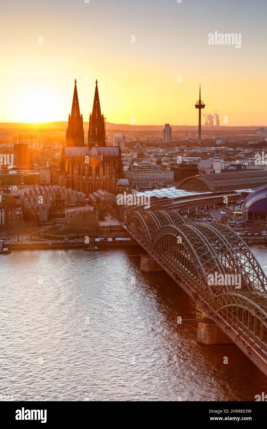 Cologne Cathedral church Germany skyline portrait format city town sunset bridge evening Stock Photo