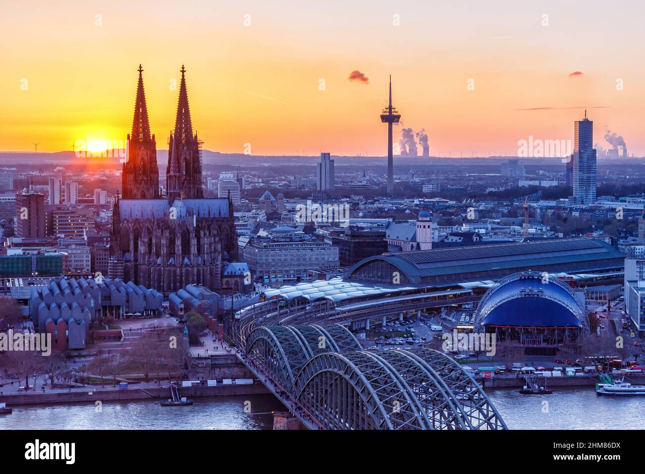 Cologne Cathedral church Germany twilight skyline city town sunset bridge evening Stock Photo