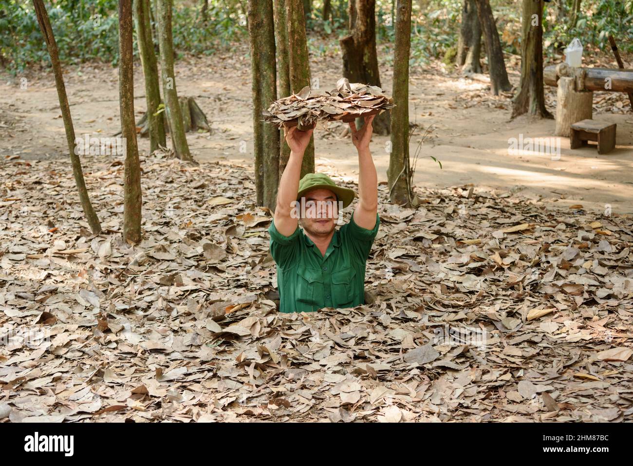 A tour guide reveals a hidden entrance to the network of tunnels at the