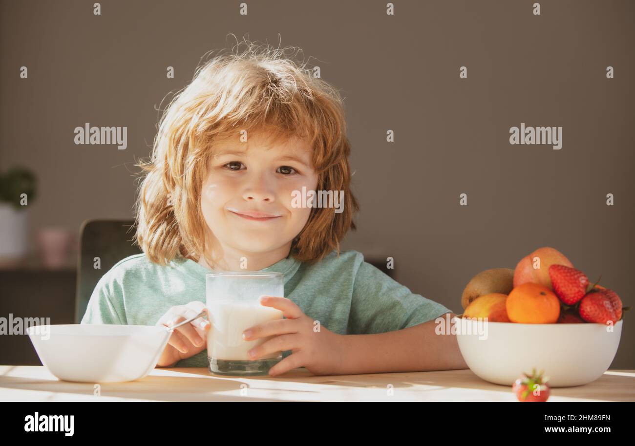 Child with glass of milk eating healthy food. Stock Photo