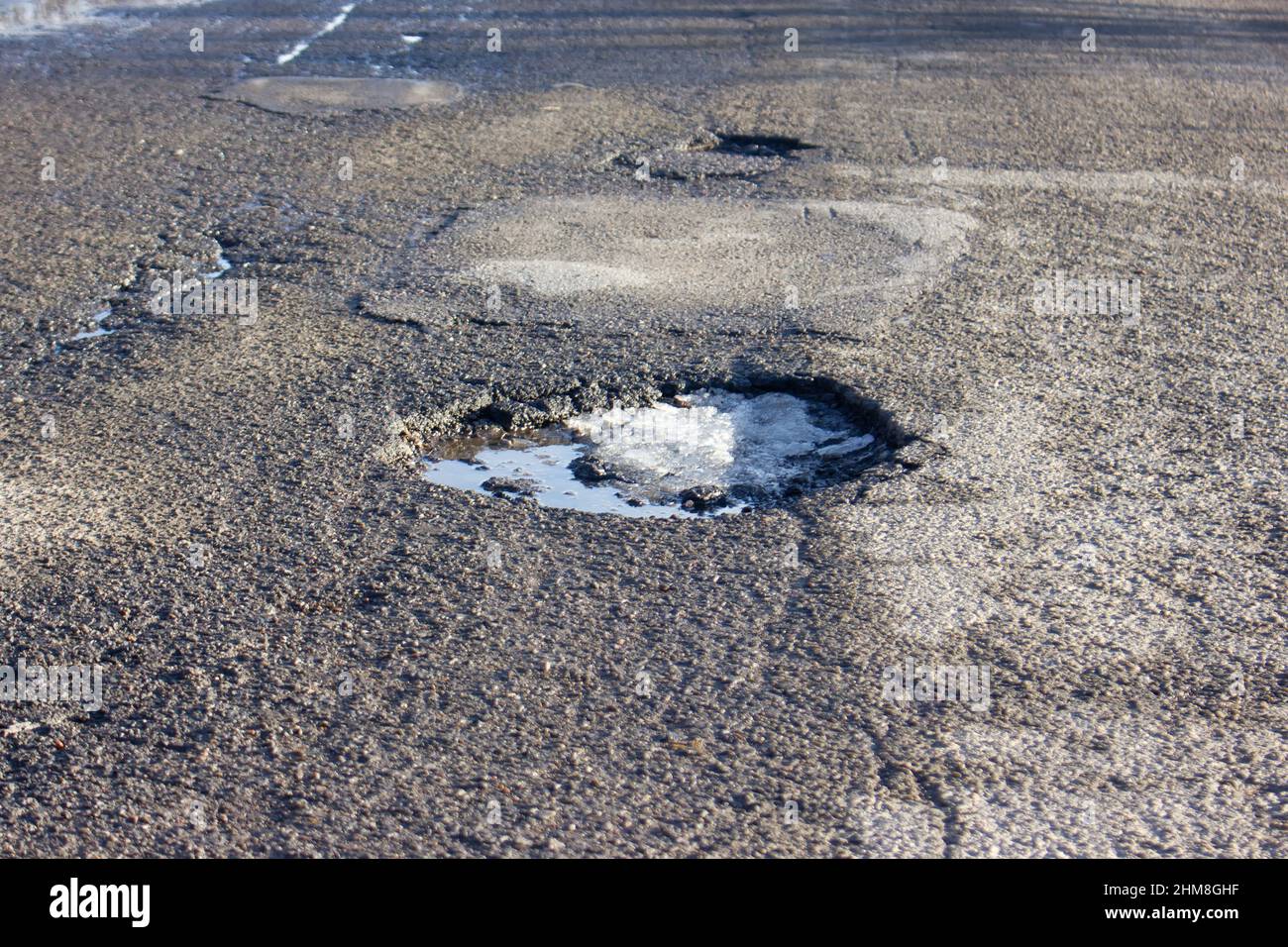 Pit on the asphalt. Broken road surface Stock Photo - Alamy