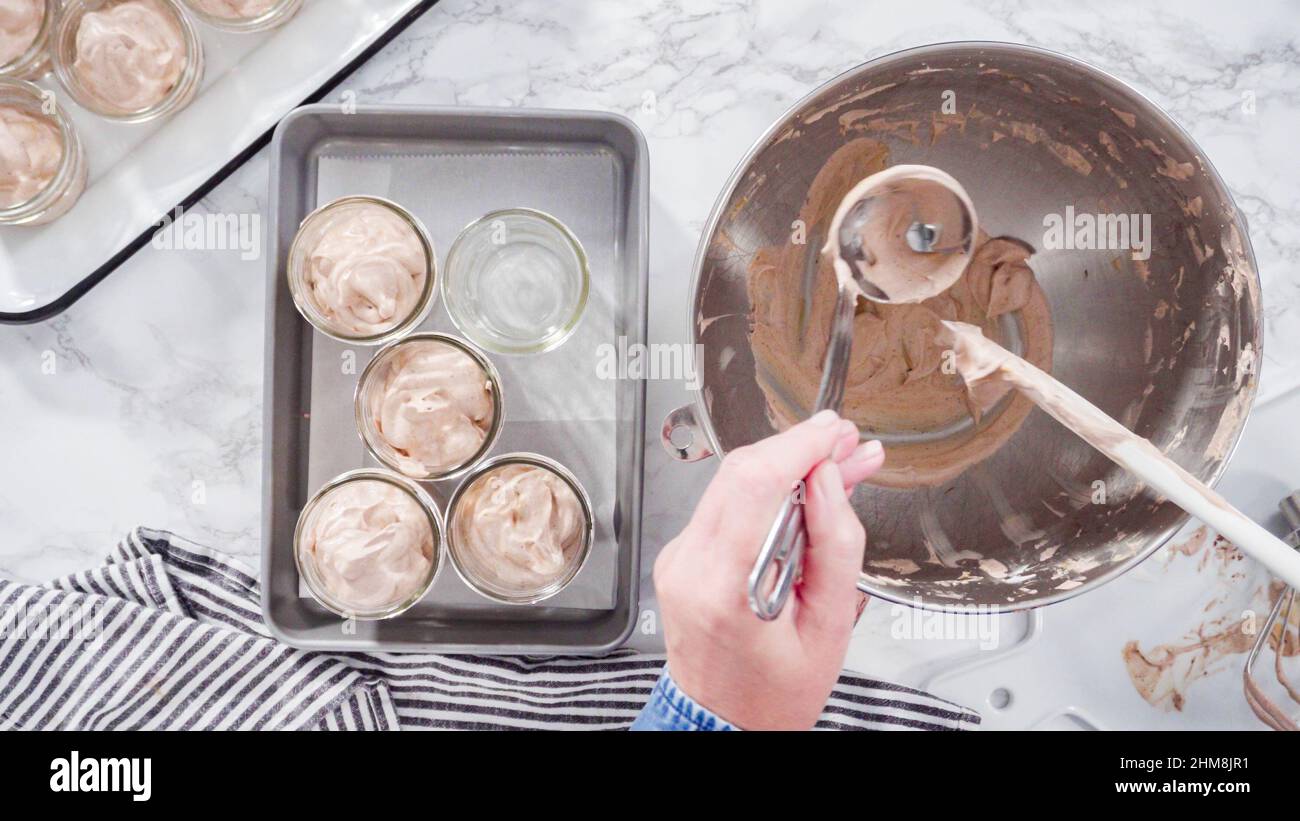 https://c8.alamy.com/comp/2HM8JR1/flat-lay-step-by-step-scooping-homemade-chocolate-ice-cream-into-glass-jars-2HM8JR1.jpg