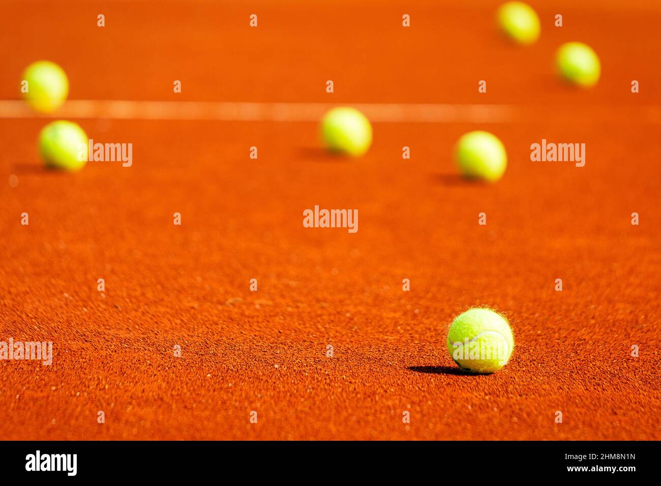 Yellow tennis balls on a clay court Stock Photo Alamy