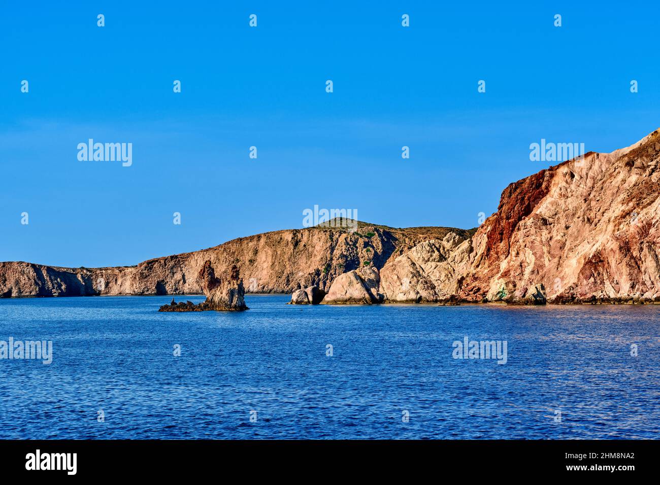 Beautiful view of hill slope of island in Mediterranean Sea. Blue waters, clear blue sky, bright sunshine, summer day, rocks and islets Stock Photo