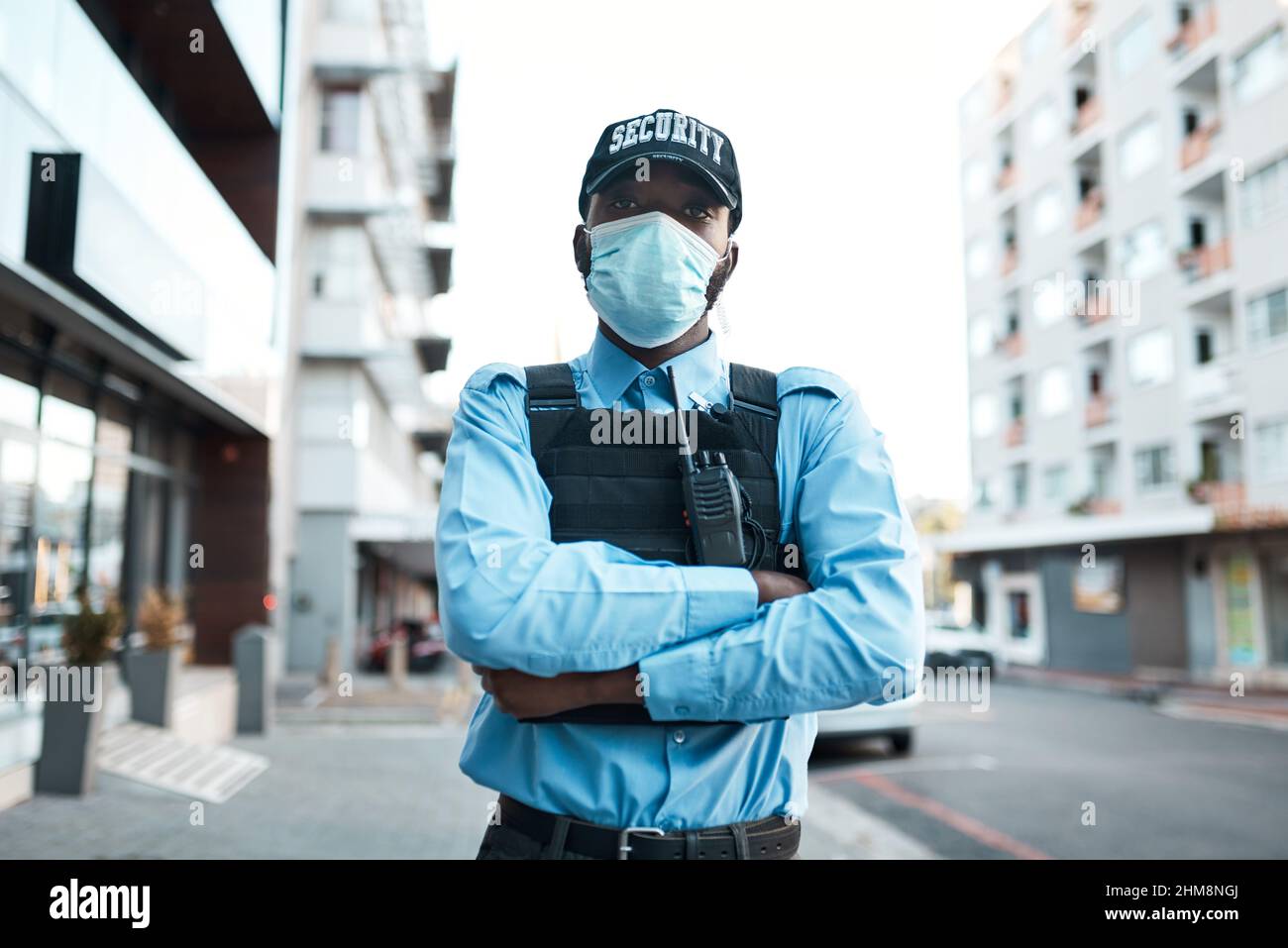 I put the pro in protect. Portrait of a confident masked young security guard standing guard outdoors. Stock Photo