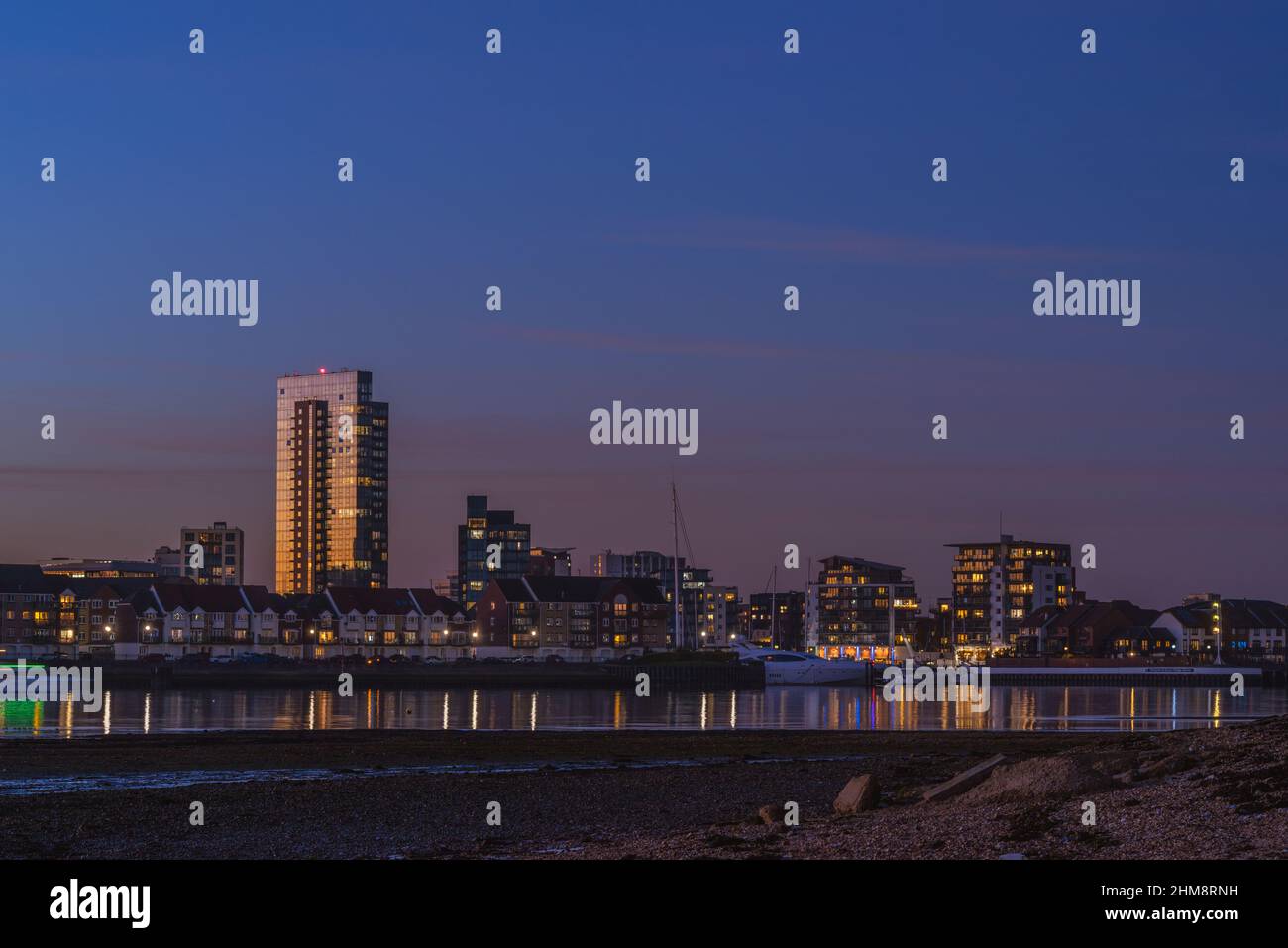 View from Weston towards Ocean Village Marina during dusk / blue hour sunset, Southampton cityscape skyline, Hampshire, England, UK Stock Photo