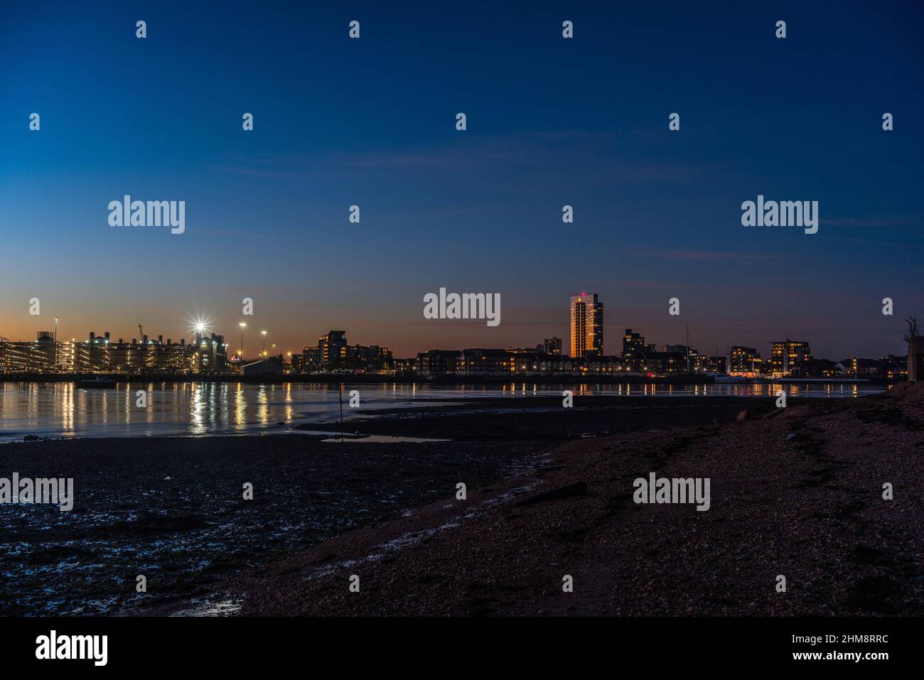 View from Weston towards Ocean Village Marina during dusk / blue hour sunset, Southampton cityscape skyline, Hampshire, England, UK Stock Photo