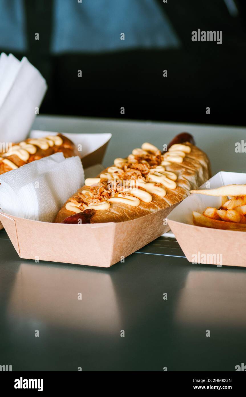 Freshly prepared hotdogs in a paper box. Food delivery concept. Stock Photo