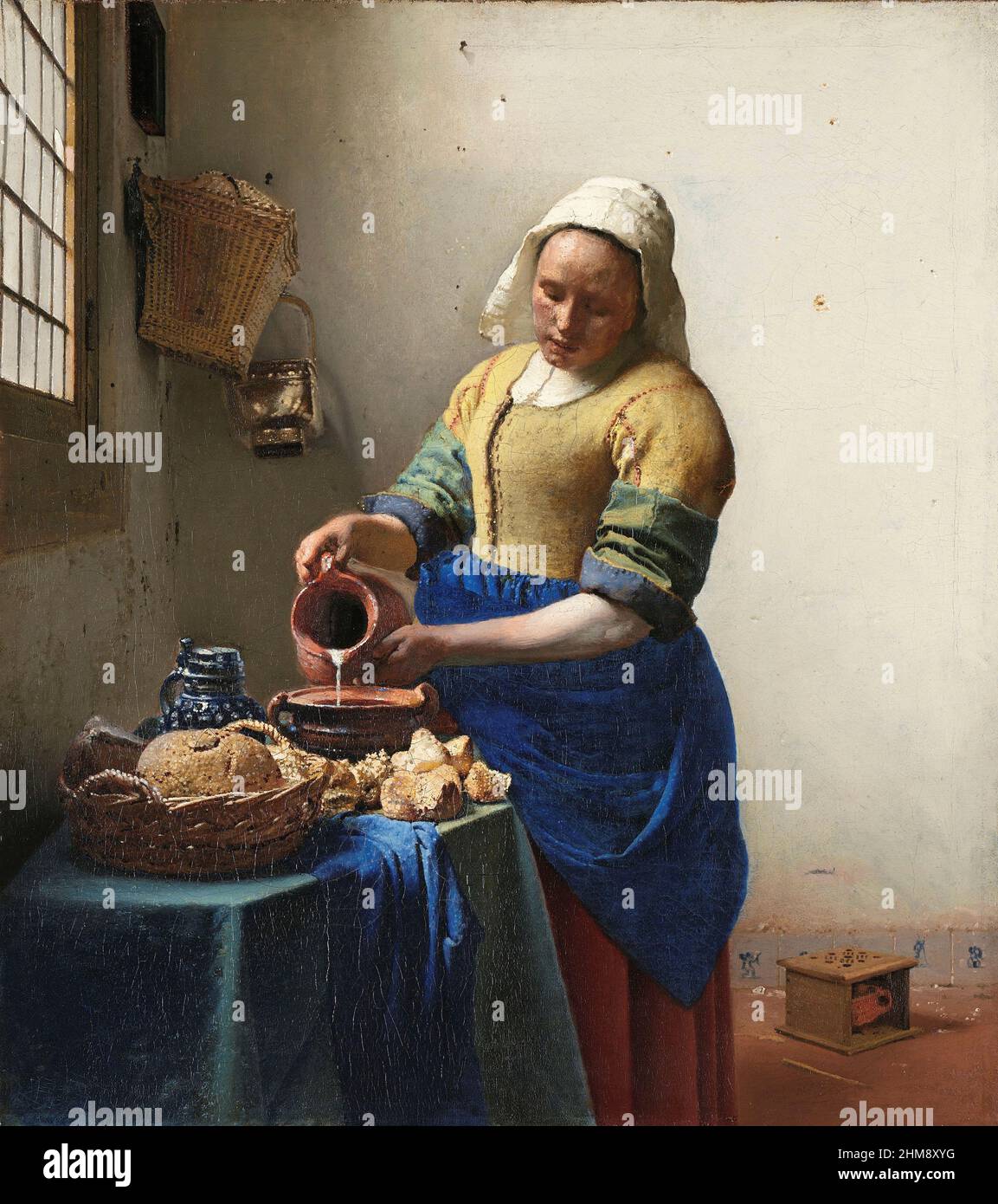The Milkmaid by Dutch Baroque Period artist Johannes Vermeer, 1632 - 1675.  On display in the Rijksmuseum, Amsterdam, Netherlands. Stock Photo