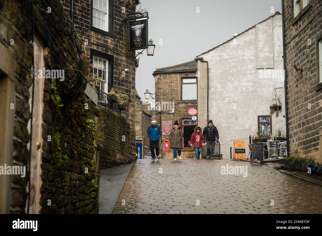 Haworth, UK: Main Street in Howarth, West Yorkshire attracts tourists from around the world because of its connections to the Bronte Sisters. Stock Photo