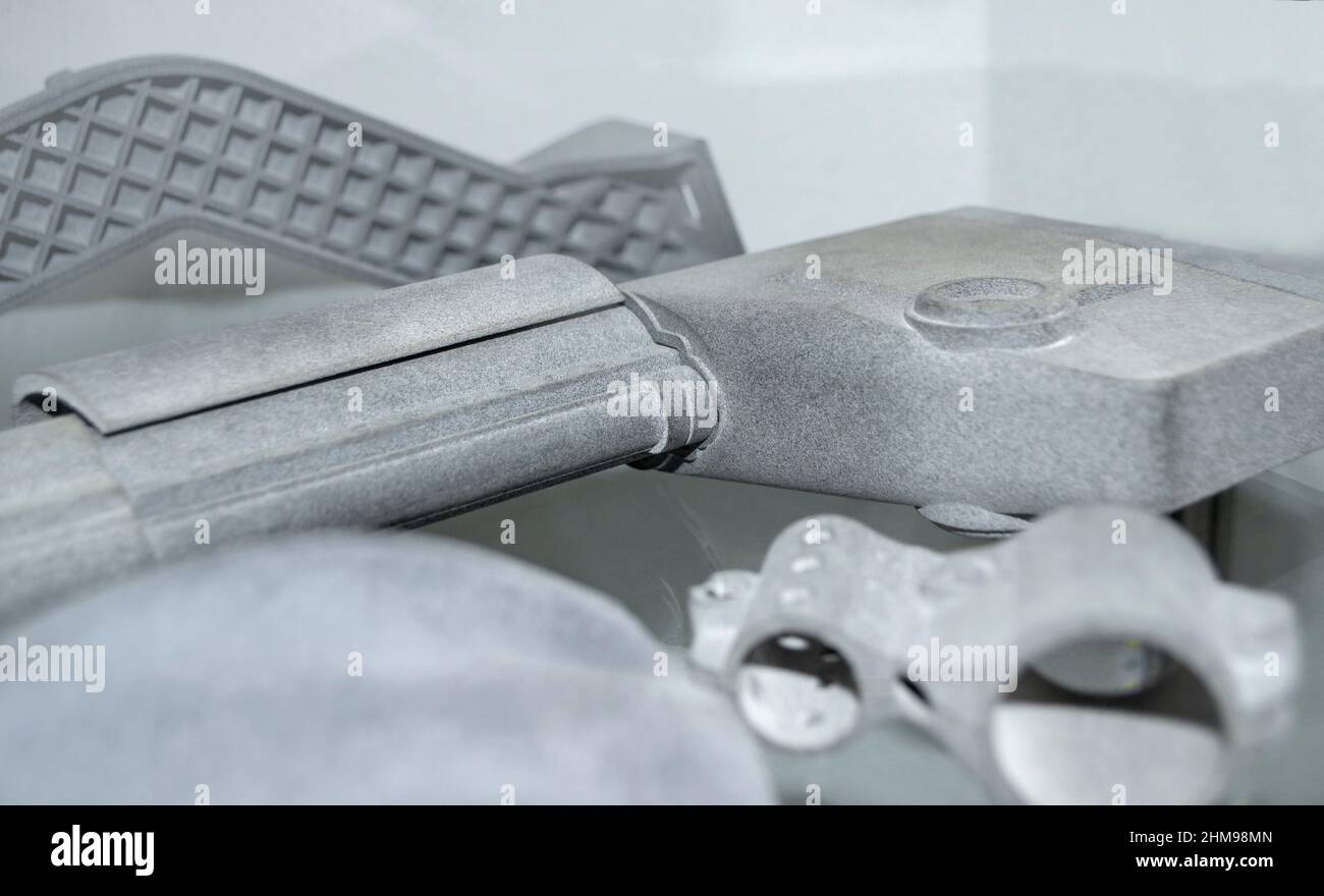Different abstract models printed on 3d printer from powder close-up ...