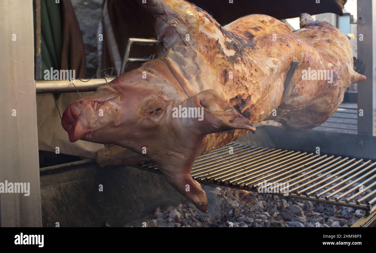 Whole pig being roasted as medieval times. Selective focus Stock Photo