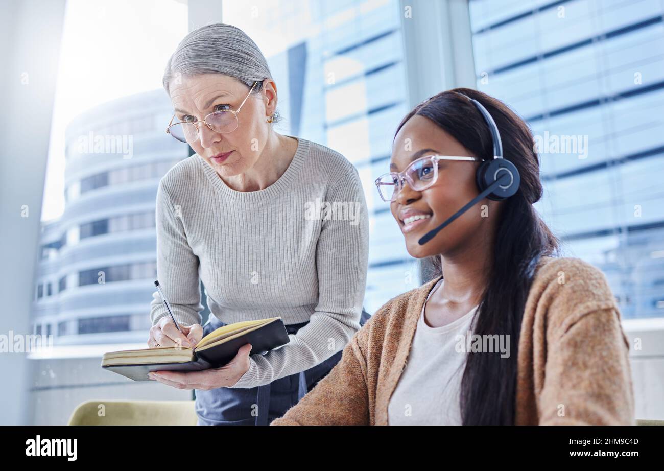 You work so fast its shocking. Shot of a young businesswoman going over some work with her manager. Stock Photo