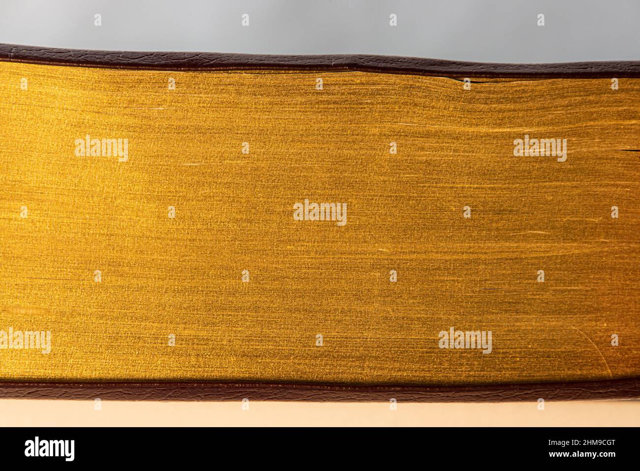 Close up of pages of a book with golden edges, golden texture