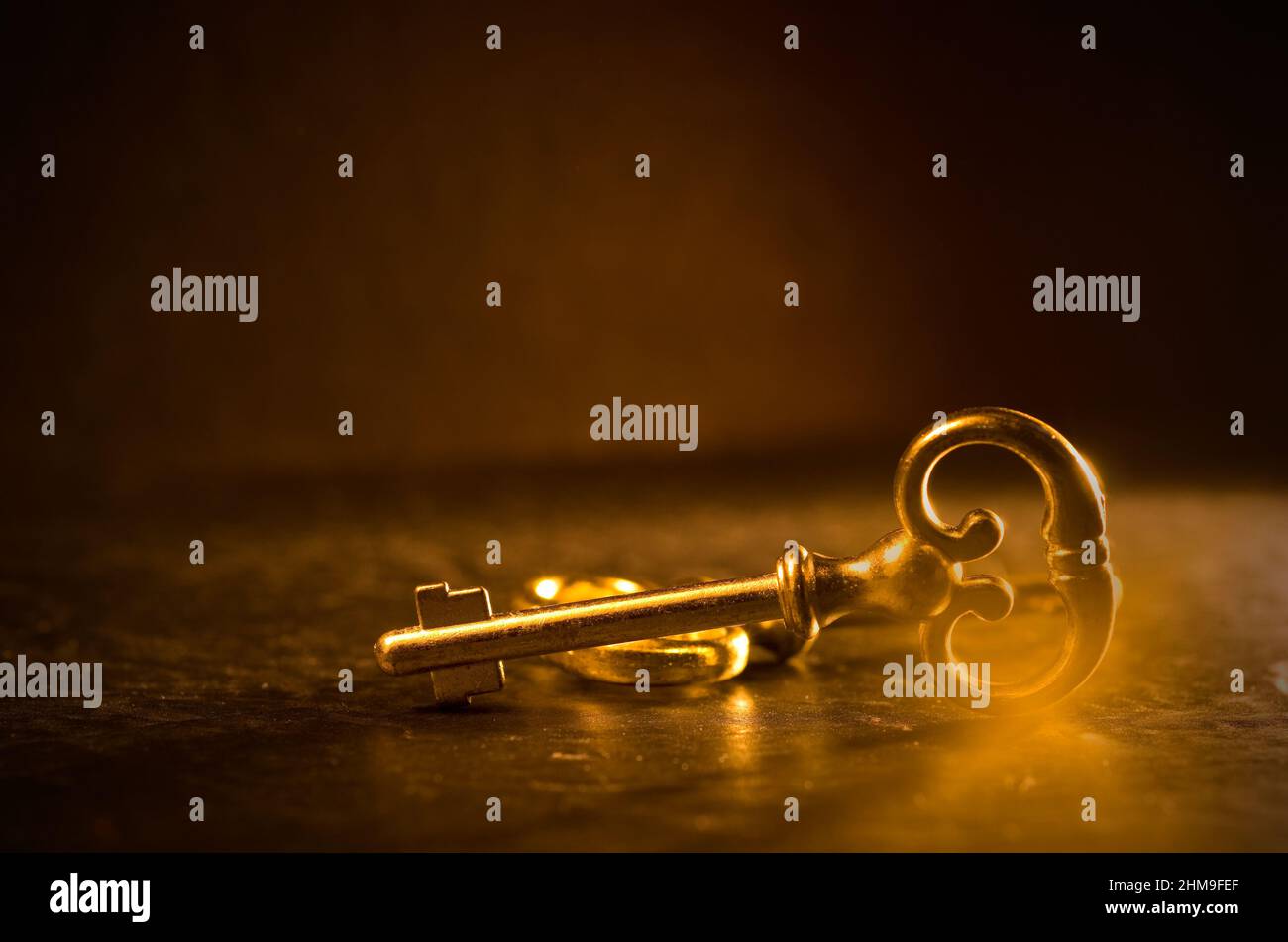 Antique Door Key with Golden Lights and Dark Background Horizontal