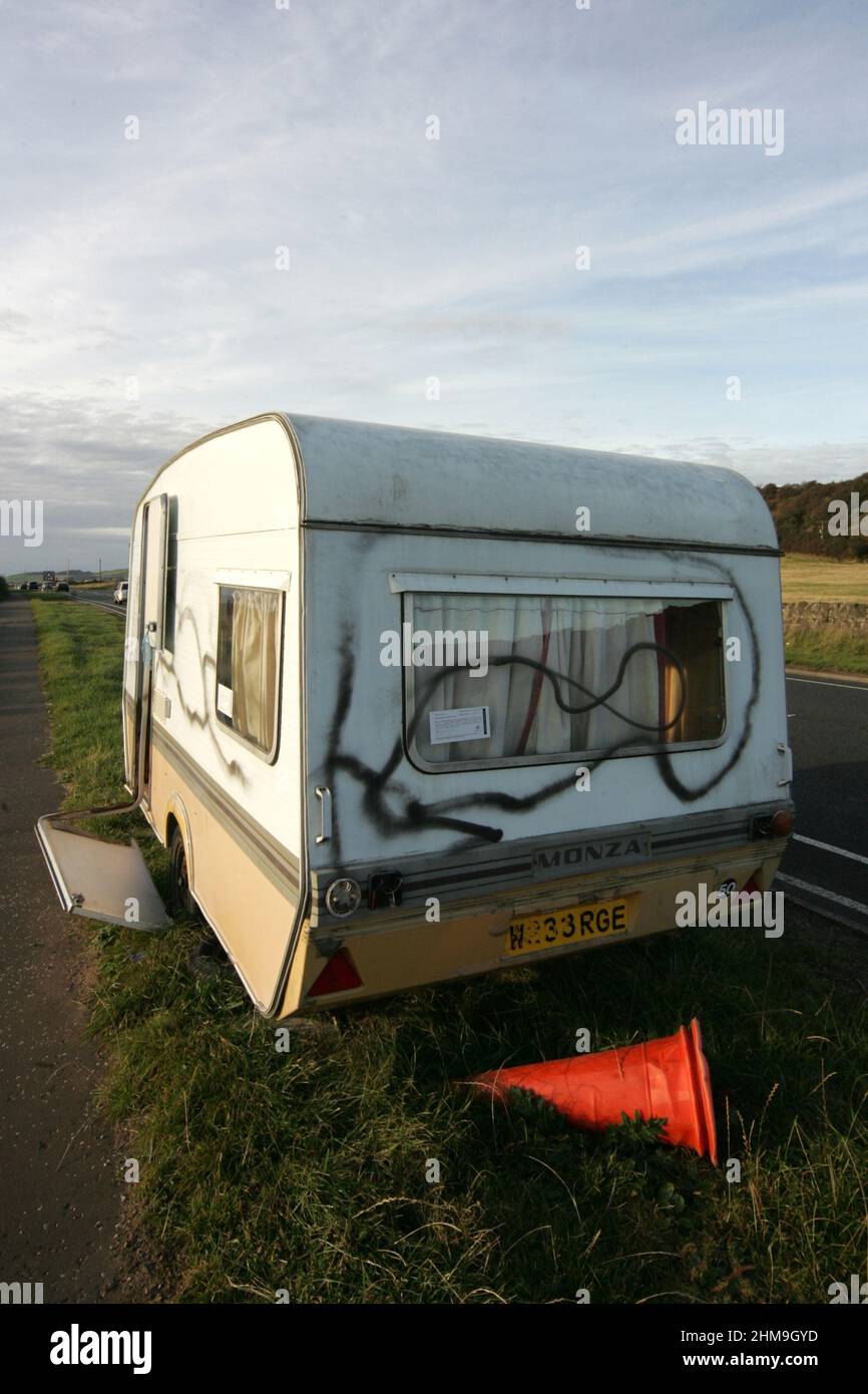 A78, near Seamill, West Kibride, North Ayrshire, Scotland, UK. An abandoned camera, vandalised on the road side verge with notice served on it pertaining to the Refuse Disposal Amenity Act  by North Ayrshire Councul giving warning that the caravan will be removed in a certain time scale Stock Photo