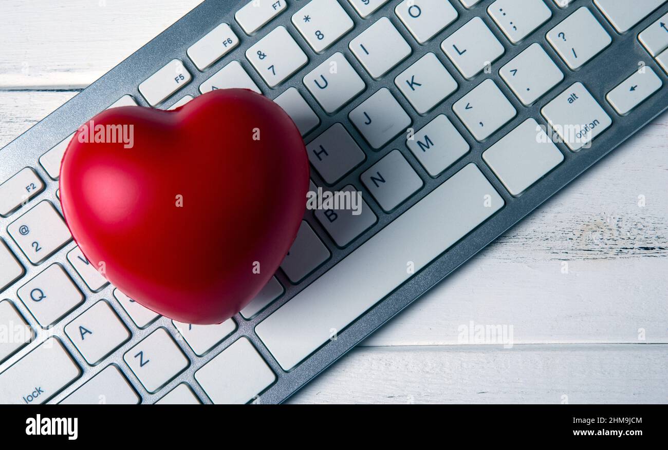 red heart on pc keyboard of notebook website Stock Photo