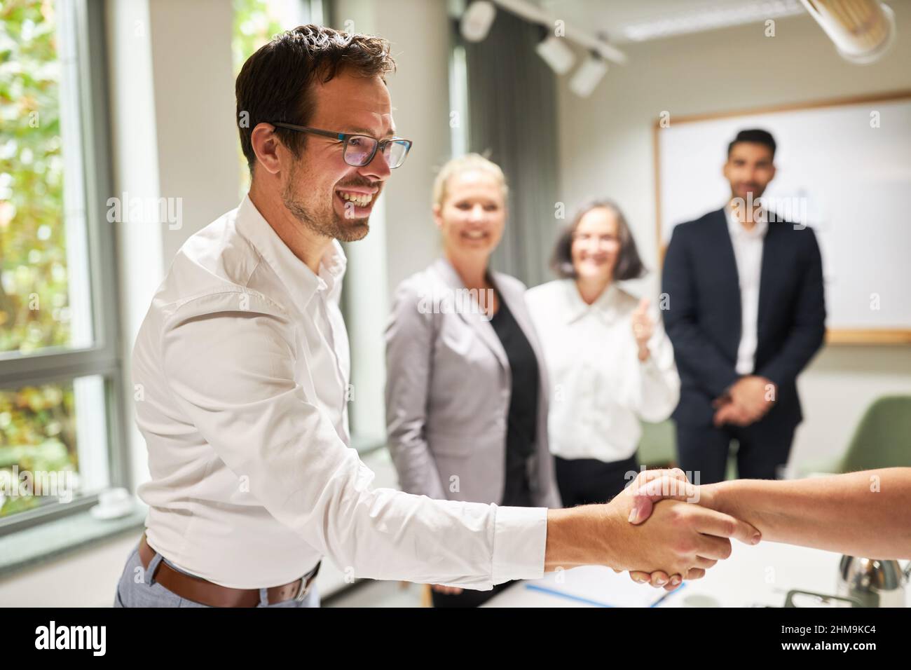 Business people shake hands as a symbol of greeting and congratulations in the conference room Stock Photo