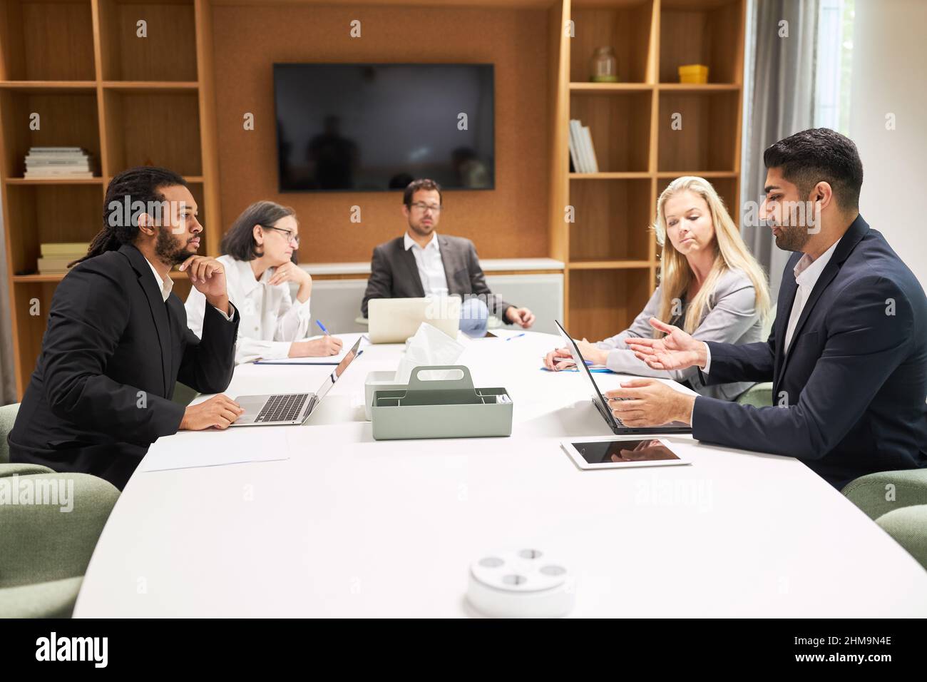 Multicultural business team at the conference table discussing project ...