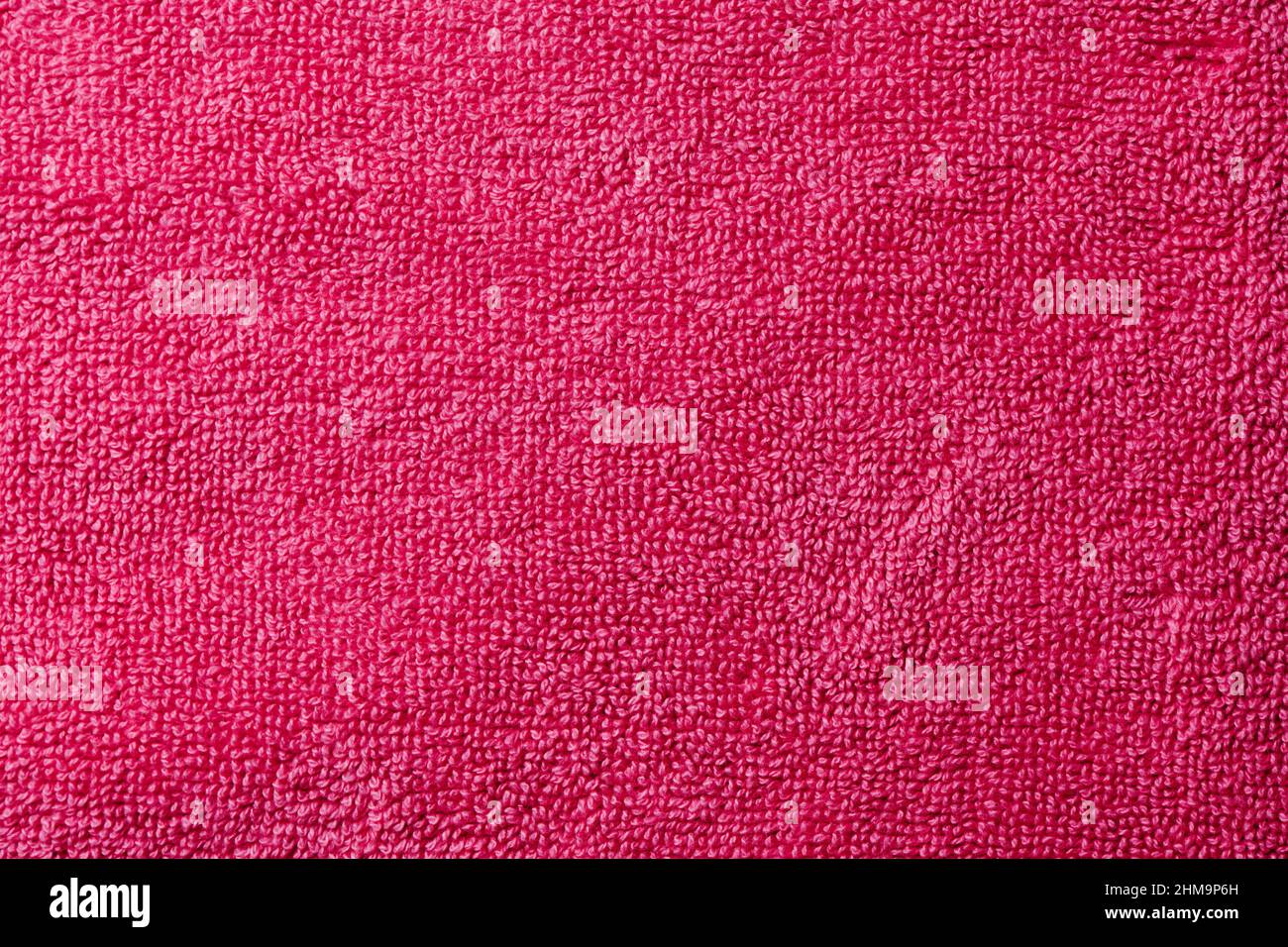 closeup of a red purple or fuchsia terrycloth fabric to be used as a background Stock Photo