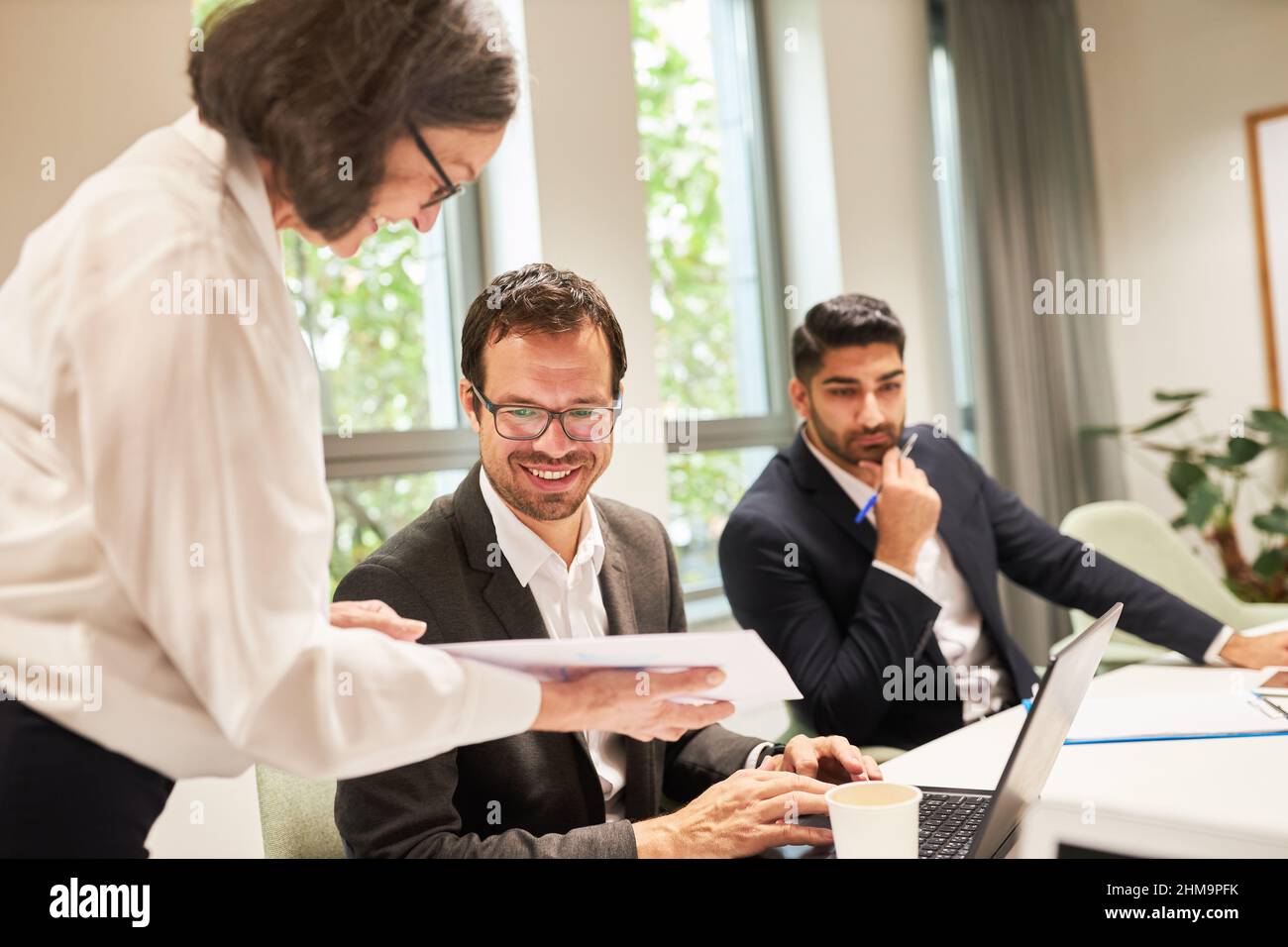 Consulting woman or boss works together with trainee in a meeting or workshop Stock Photo