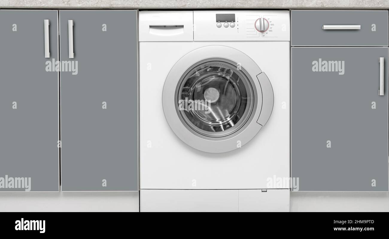 Washing machine built into the furniture Stock Photo Alamy