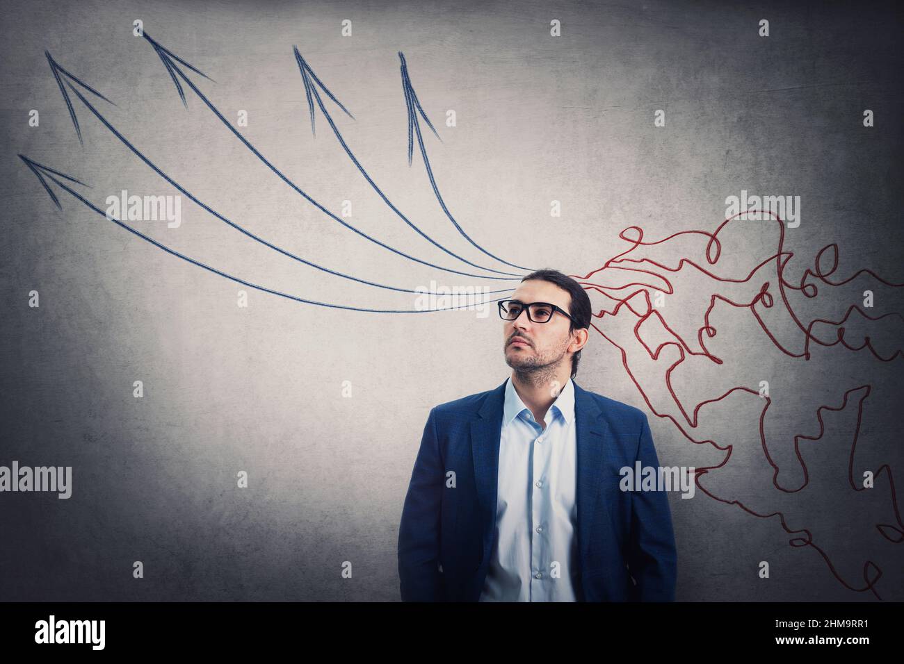 Successful businessman looking away contemplating. Information processing concept as imaginative mess lines comes through head and transform into stra Stock Photo