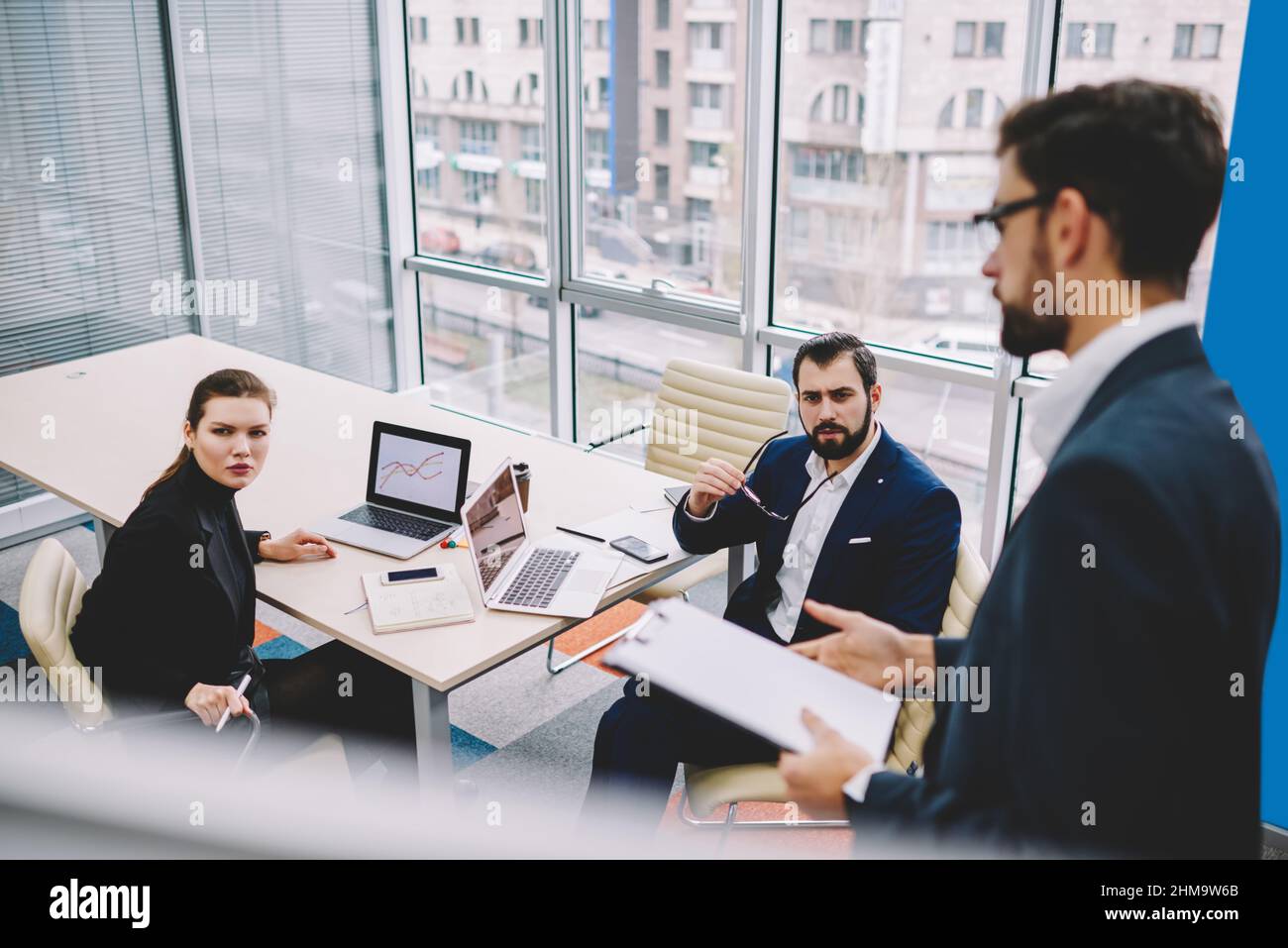 Focused colleagues working in modern workspace in daytime Stock Photo