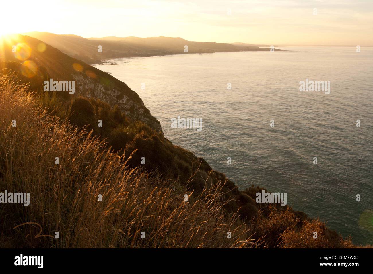 romantic sunset at hilly seaside Stock Photo