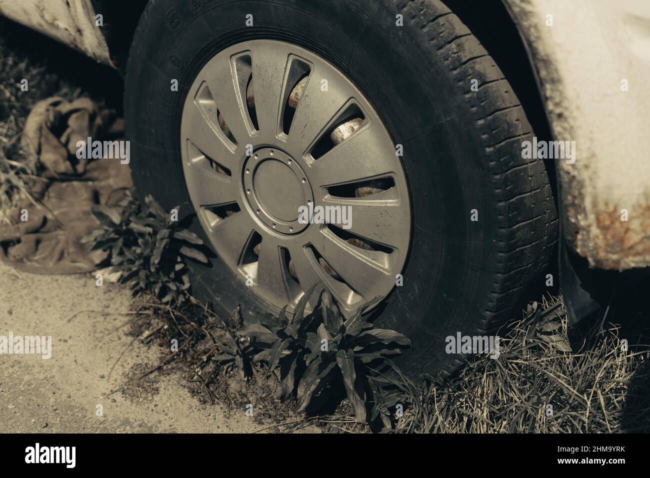 Old rusty car wheel. Cracked tires and a rusted hubcaps Stock Photo Alamy