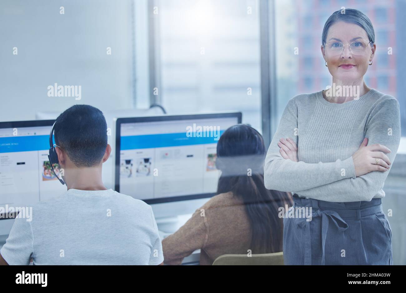 Ensuring that my staff always work at their peak. Shot of a female manager in the office with her staff members. Stock Photo