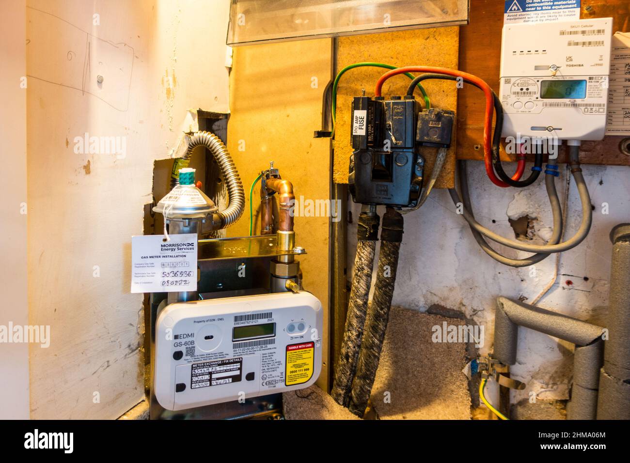 Smart electric meter and Smart gas meter installation under stairs in a household designed to end estimated billing and replace with accurate readings Stock Photo