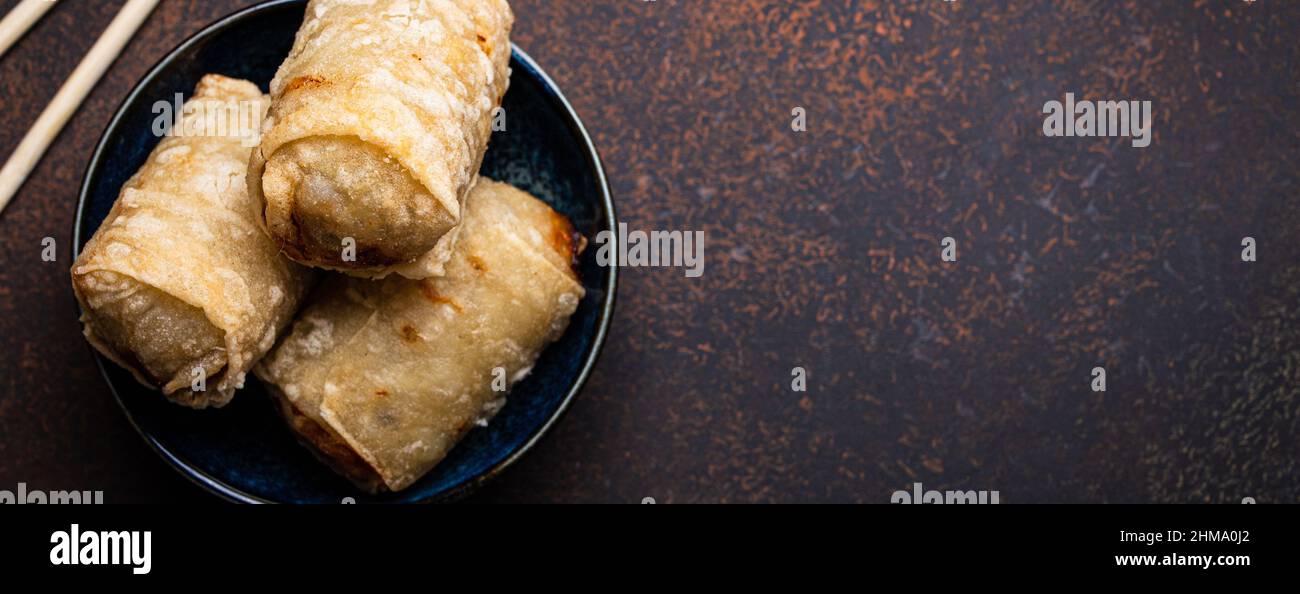 Chinese, Thai or Vietnamese traditional dish deep fried spring rolls with filling on plate Stock Photo