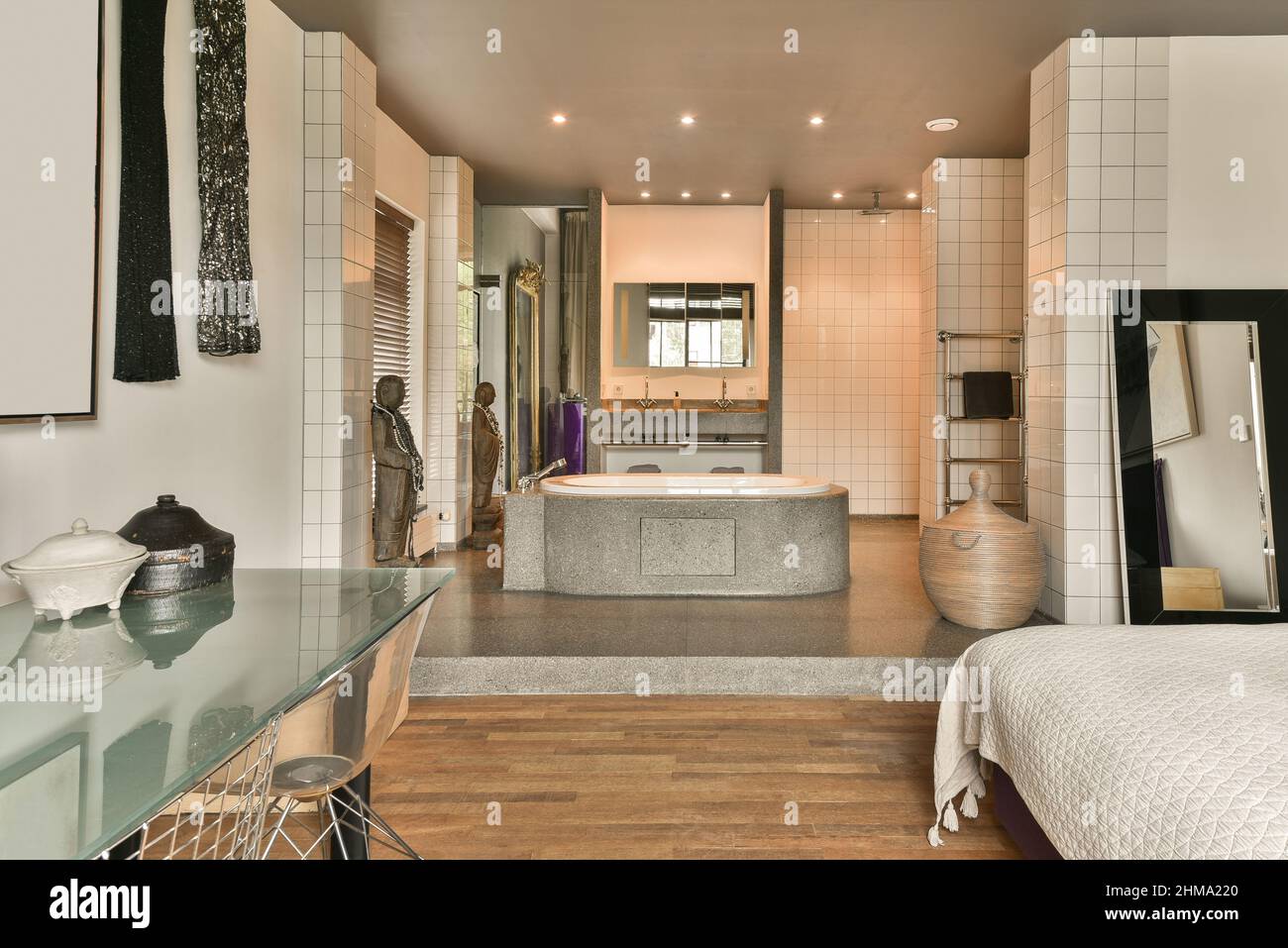 Modern open plan bathroom interior with ceramic bathtub and bedroom